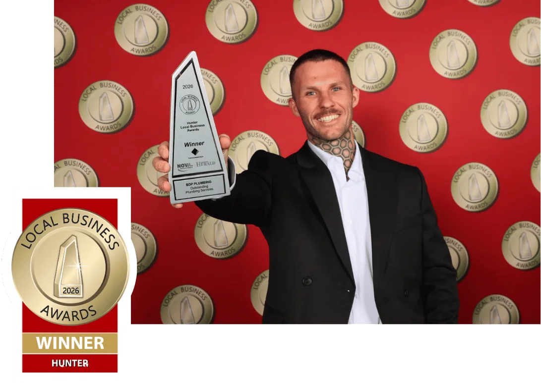 Plumber holding the 2026 Hunter Local Business Awards trophy