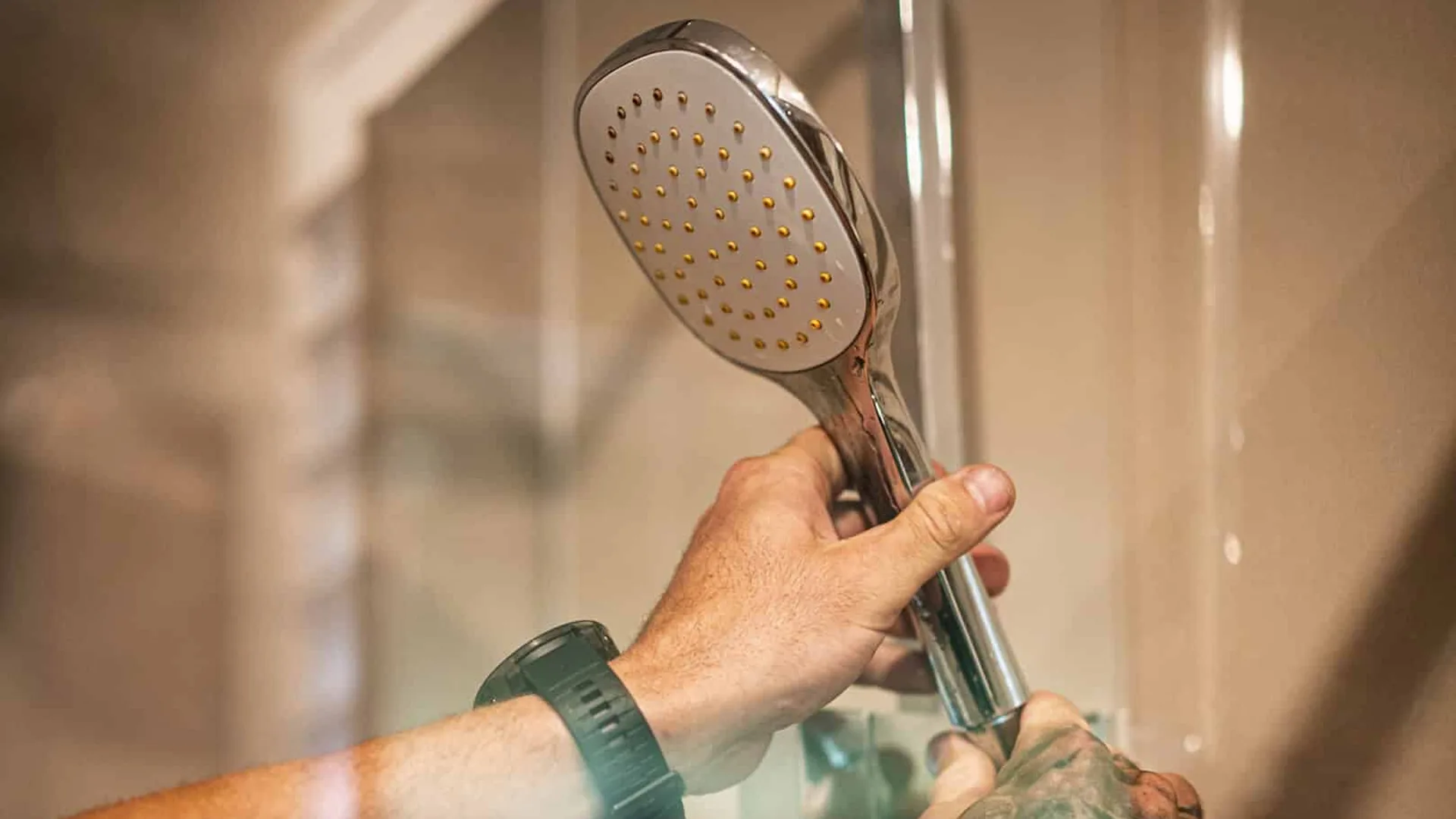 Plumber fitting a hand-held shower head